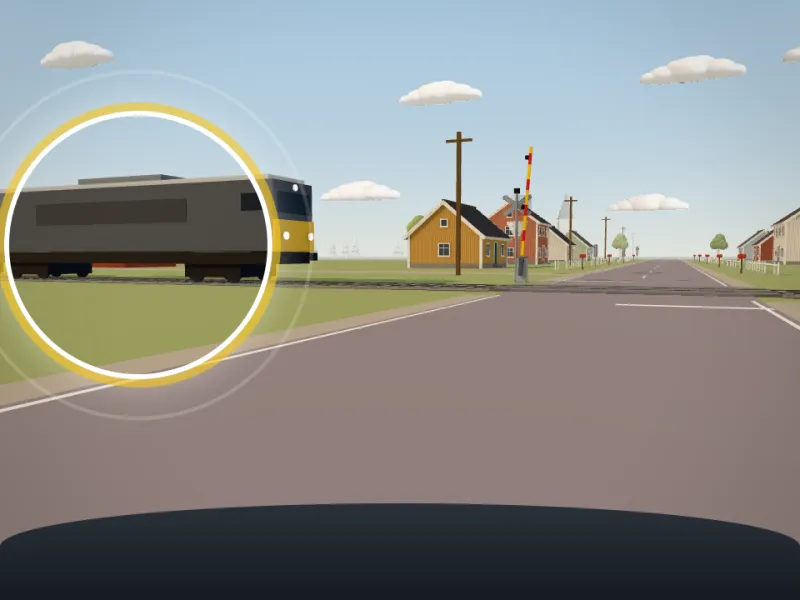 Förarvy vid en plankorsning med släckta signaler och uppfällda bommar. Ett tåg närmar sig från vänster.